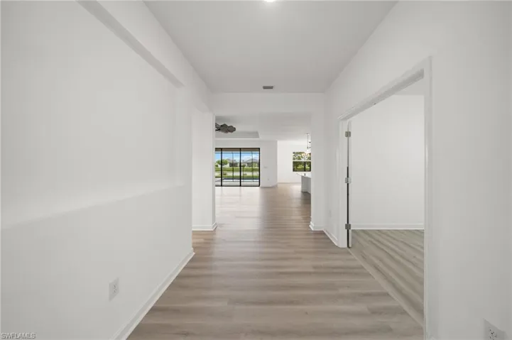 Hall featuring light wood-style floors and baseboards