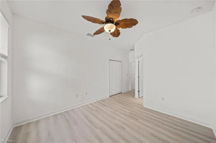 Unfurnished room featuring light wood-type flooring and baseboards