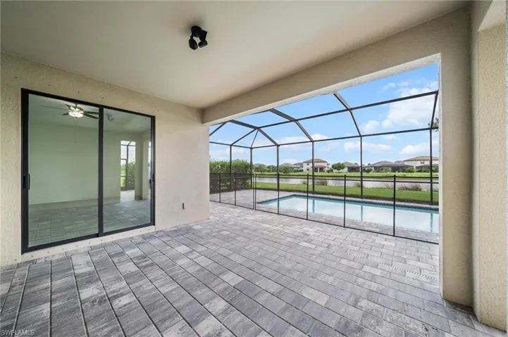 View of patio / terrace featuring an outdoor pool and a lanai