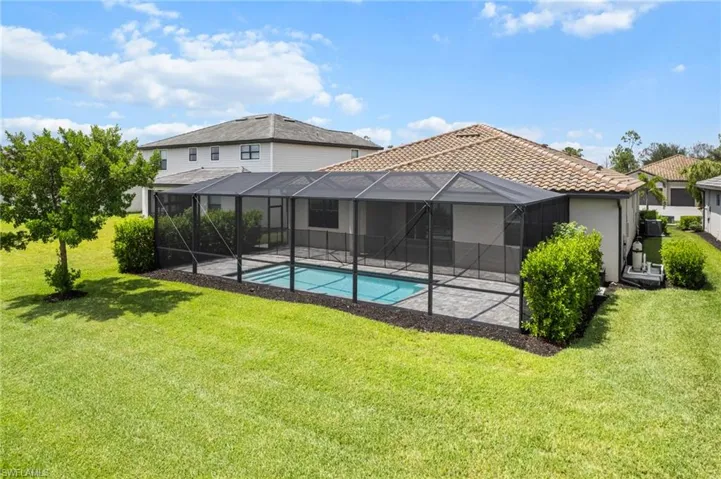 Rear view of property with a yard, an outdoor pool, a patio area, and stucco siding