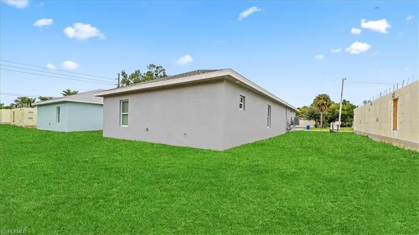 View of side of home with stucco siding