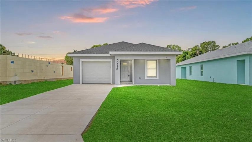 View of front of house featuring concrete driveway, stucco siding, an attached garage, and roof with shingles