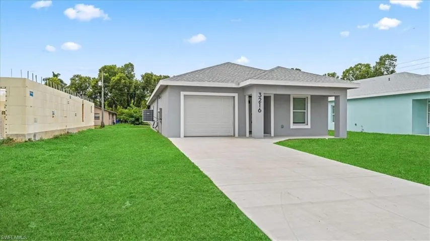 View of front of property featuring concrete driveway, stucco siding, an attached garage, and roof with shingles