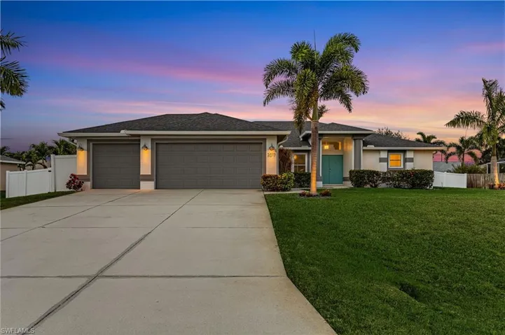 View of front of property with a garage, driveway, stucco siding, and a shingled roof