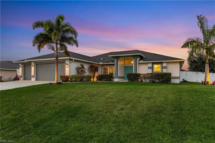 House at dusk with exterior landscape lights