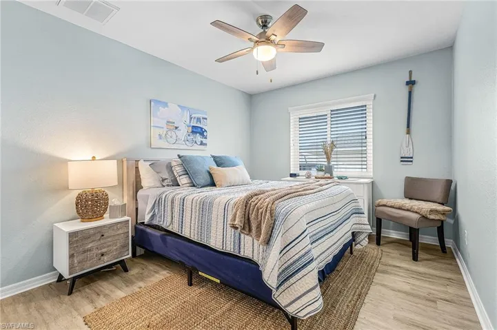 Guest Bedroom #2 featuring ceiling fan and light wood finished floors