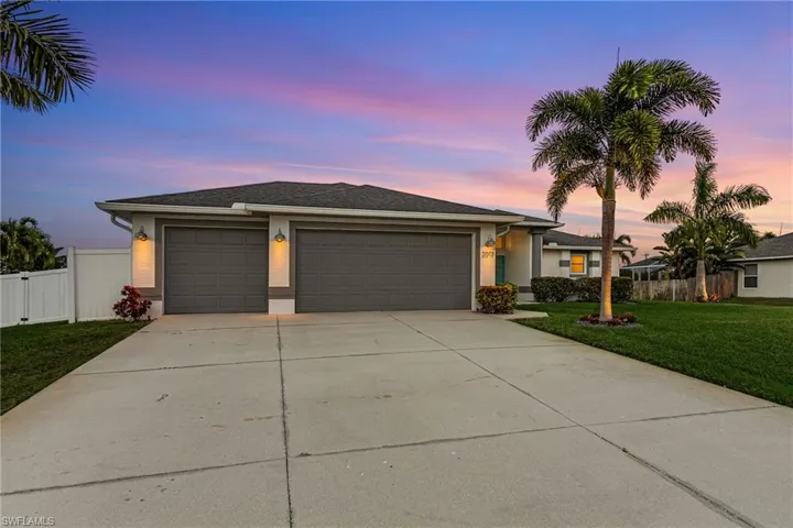 View of front of house with stucco siding, concrete driveway, and an attached 3 car garage