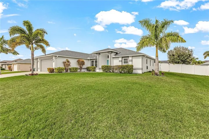 View of front of property with stucco siding, an attached garage, and concrete driveway