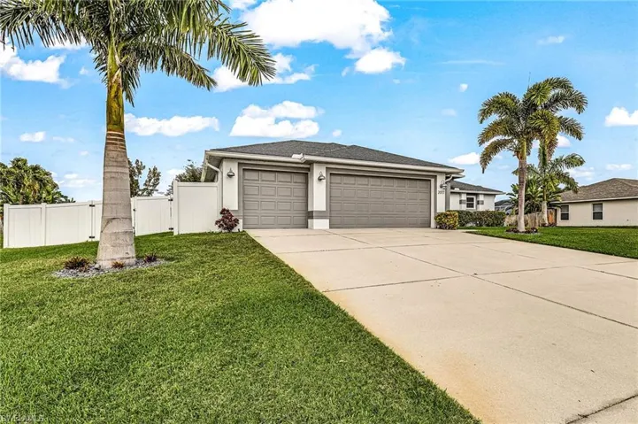 View of front facade featuring stucco siding, a garage, and concrete driveway