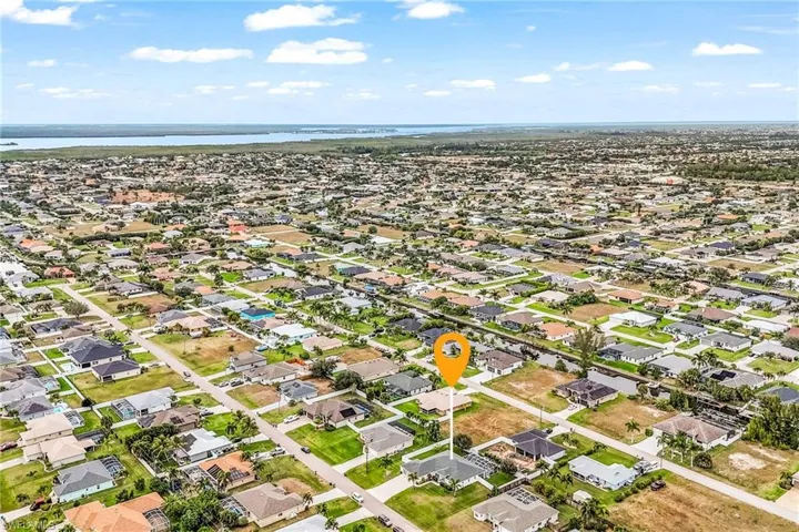 Aerial view of residential area featuring a nearby body of water