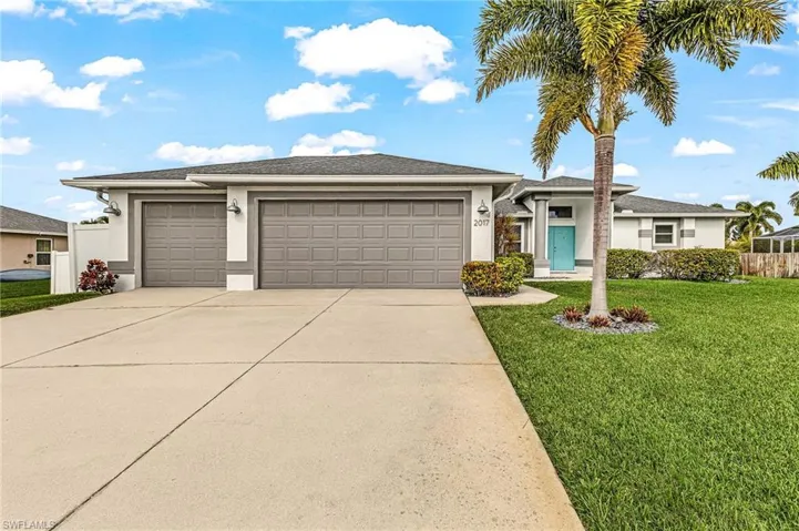 Prairie-style home with a 3 car garage, stucco siding, driveway, and roof with shingles