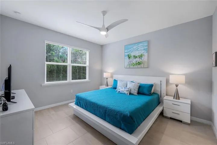 Bedroom featuring ceiling fan and light tile floors