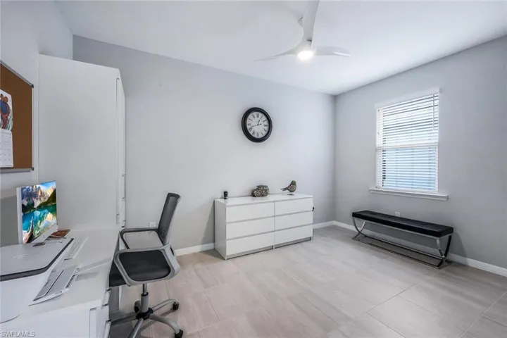 Tiled office featuring ceiling fan