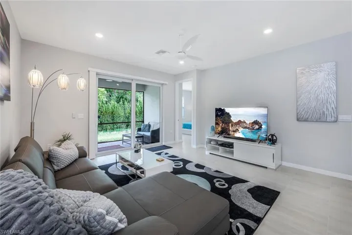 Living room featuring tile flooring and ceiling fan
