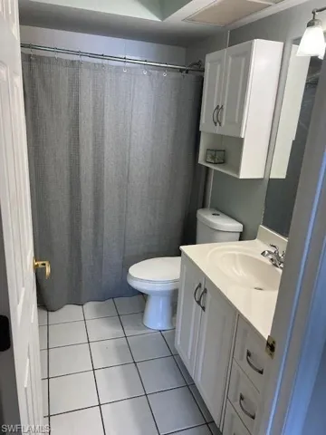 Bathroom with tile patterned floors, vanity, and toilet