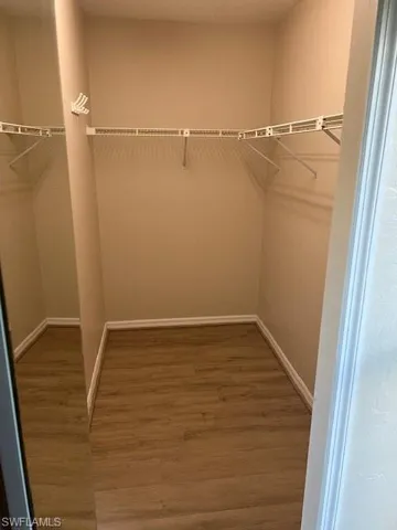 Walk in closet featuring hardwood / wood-style floors