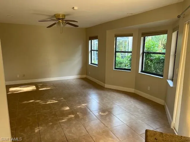 Tiled empty room with ceiling fan