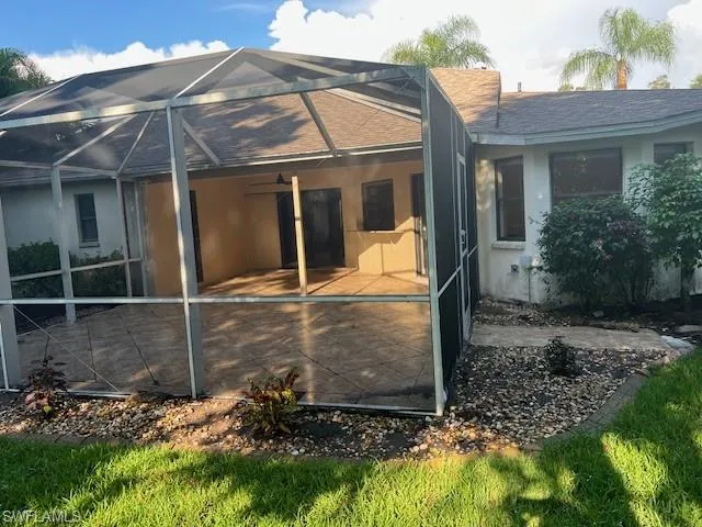 Back of house with a patio area and a lanai