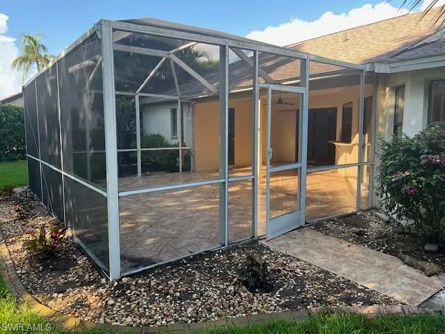 Back of house featuring glass enclosure