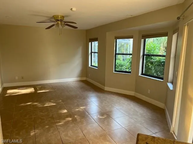 Tiled empty room with ceiling fan