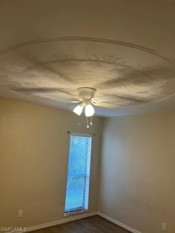 Spare room featuring ceiling fan and hardwood / wood-style floors