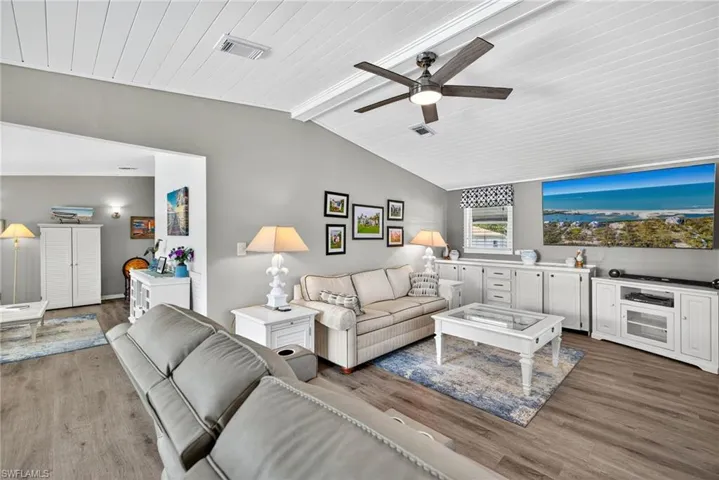Living room featuring wood finished floors, wood ceiling, and a ceiling fan
