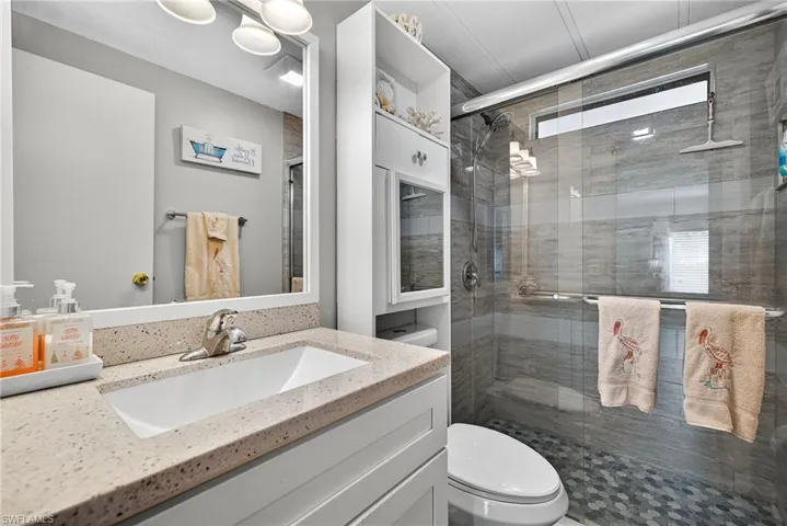 Bathroom featuring vanity and a stall shower