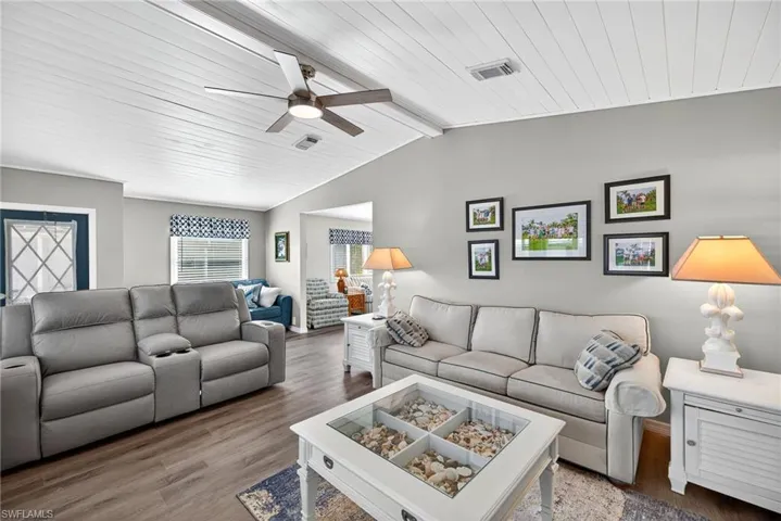 Living area with wood finished floors, a ceiling fan, and wood ceiling