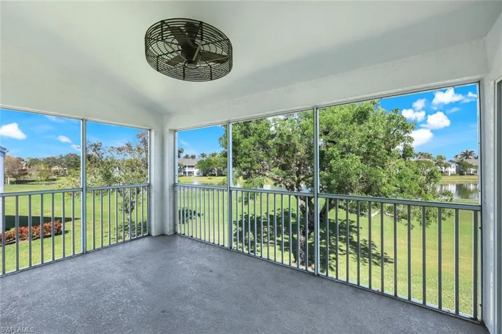 Unfurnished sunroom with vaulted ceiling, a water view, and a healthy amount of sunlight
