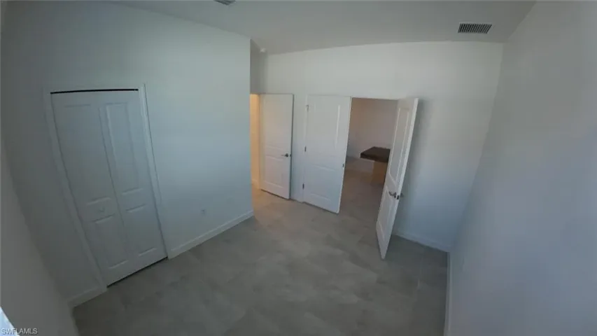 Unfurnished bedroom with a closet and light flooring