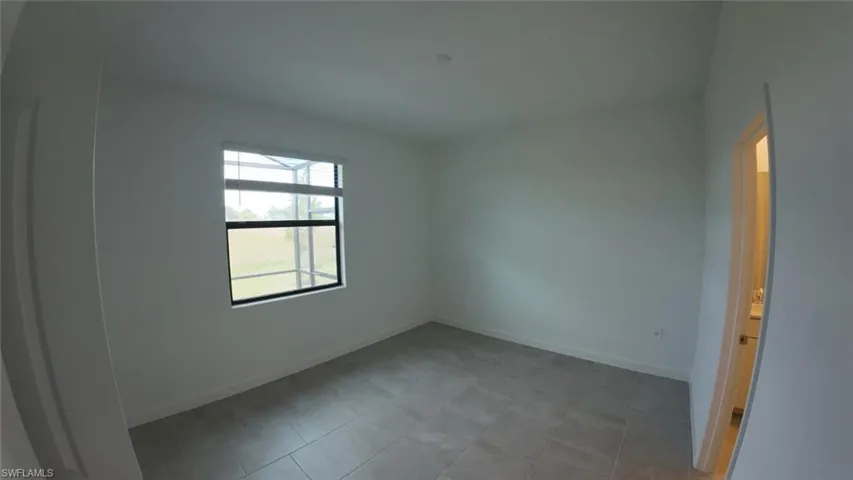 Spare room featuring baseboards