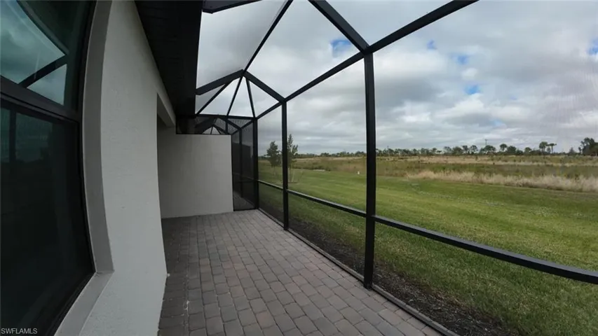 Unfurnished sunroom featuring a rural view and a patio