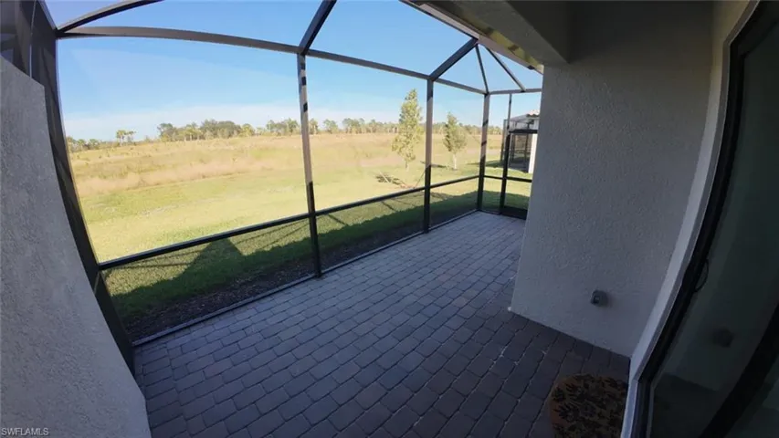 Unfurnished sunroom featuring a view of countryside