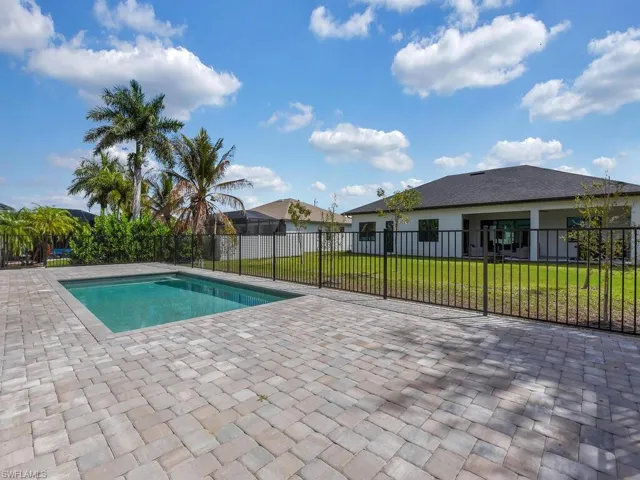 View of pool with patio surround and a fenced backyard