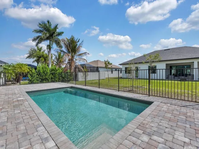 View of pool featuring patio surround and a fenced backyard