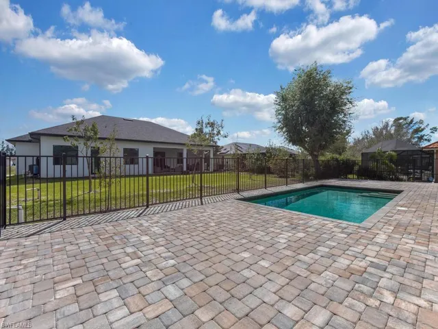 View of pool with patio surround and a fenced backyard