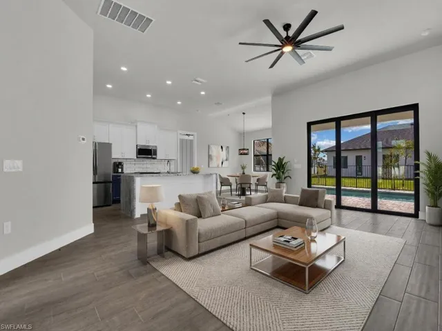 Living room featuring ceiling fan, wood finished floors, and recessed lighting