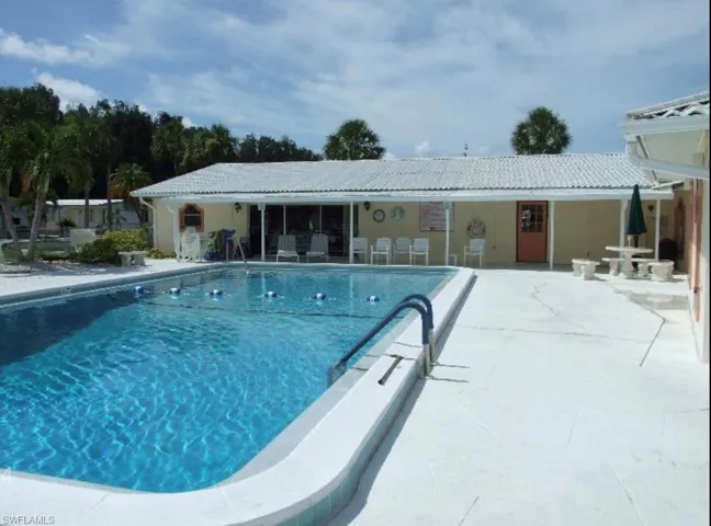 Community pool with a patio
