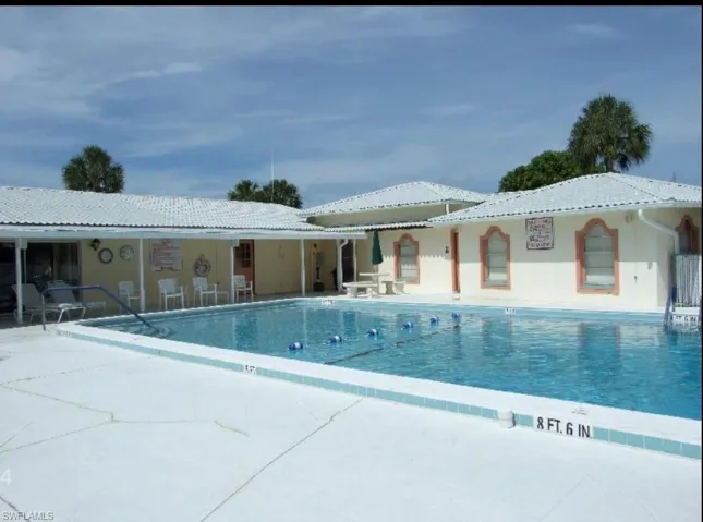 Community pool featuring a patio