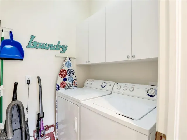 Laundry area with cabinets,  washing machine and dryer.