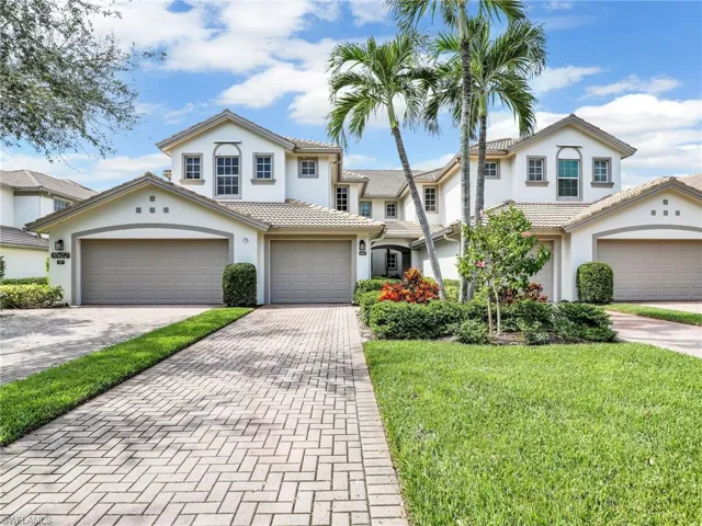 Mediterranean / Spanish-style home featuring a garage and a front lawn