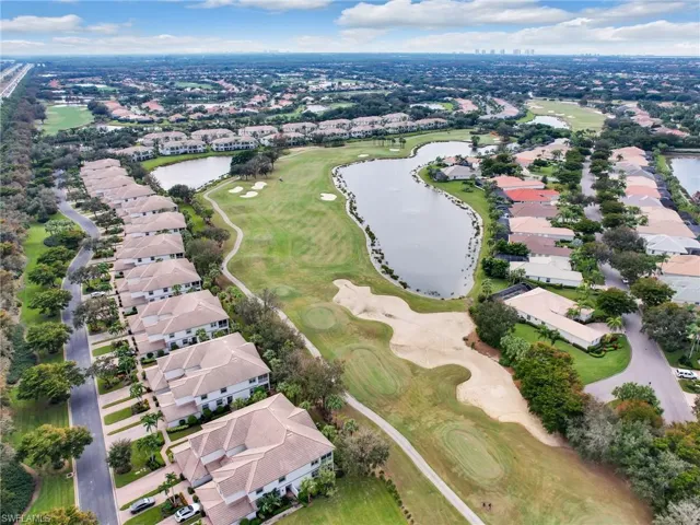 Drone / aerial view with a water and golf course view.
