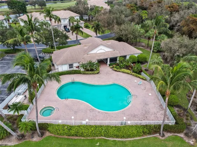 View of swimming pool featuring a patio area and club house.