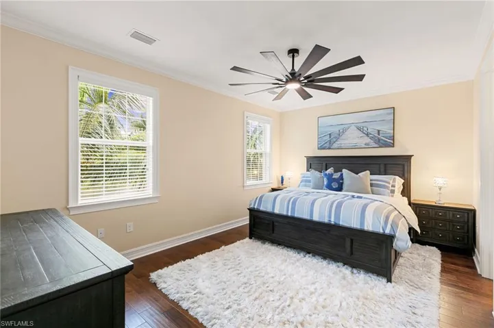 Primary Suite has tons of natural light, hardwood floors, custom tailored woodwork & the BEST fan!