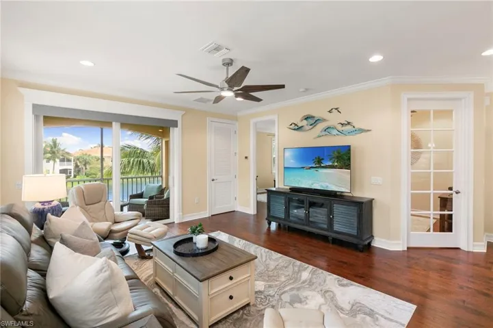 Living Area features hardwood floors, tailored woodwork & remote Smart Shades