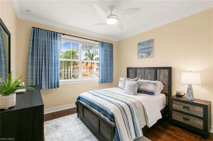 Guest Bed with hardwood floors, custom Built-In Closet & window treatments.