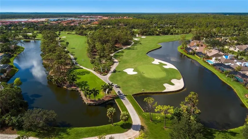 Aerial view of property and surrounding area with a local golf course and a large body of water