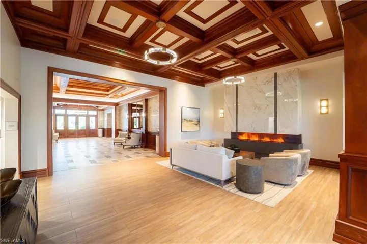Common area with coffered ceiling, beam ceiling, and crown molding