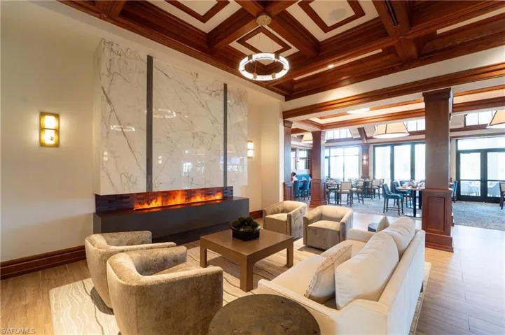Building lobby featuring coffered ceiling, beam ceiling, crown molding, and a high ceiling