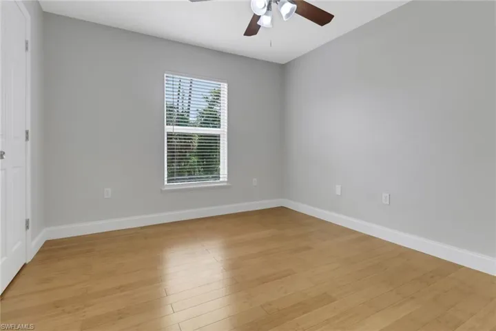 Spare room featuring ceiling fan and light hardwood / wood-style flooring